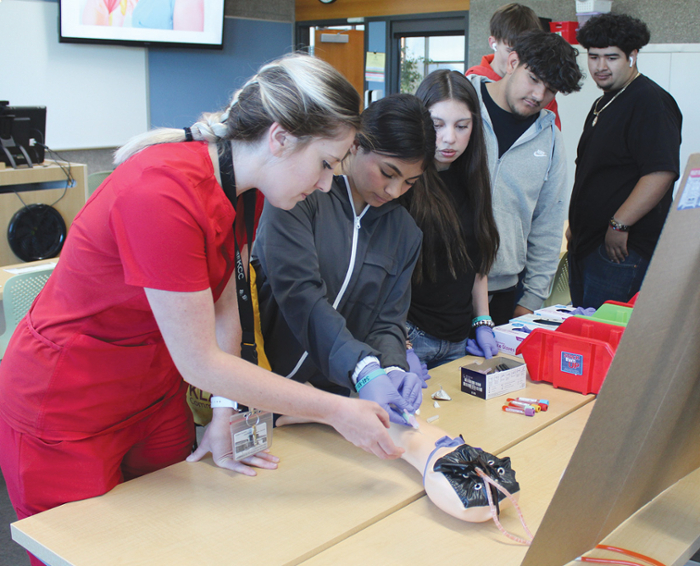 Area high school students try their hand at drawing blood during a Career Day demonstration on the KCC campus last spring.